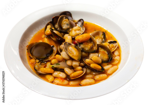 White beans with clams is traditional recipe in the Basque Country. Spain. Isolated over white background