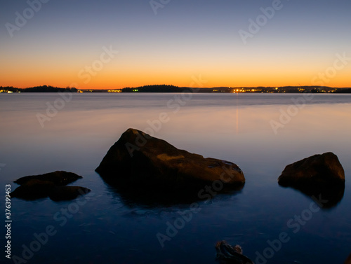 Sunset on the lake with rocks in Tampere, Finland