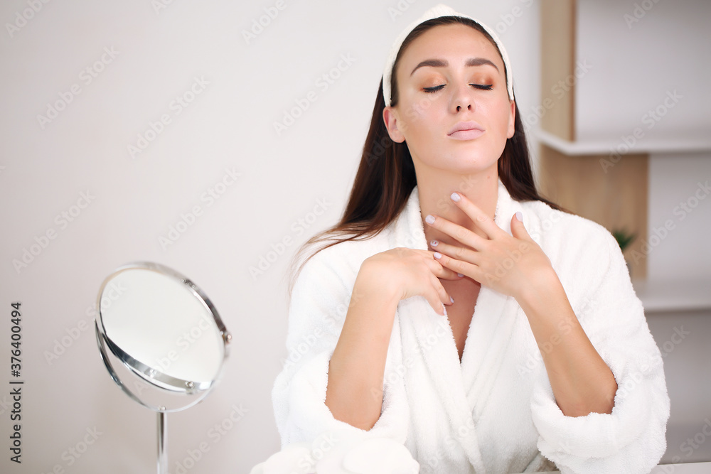 beautiful brunette in a bathrobe at home, brings beauty, a hoop on his head beautiful brunette in a bathrobe at home, brings beauty, a hoop on his head