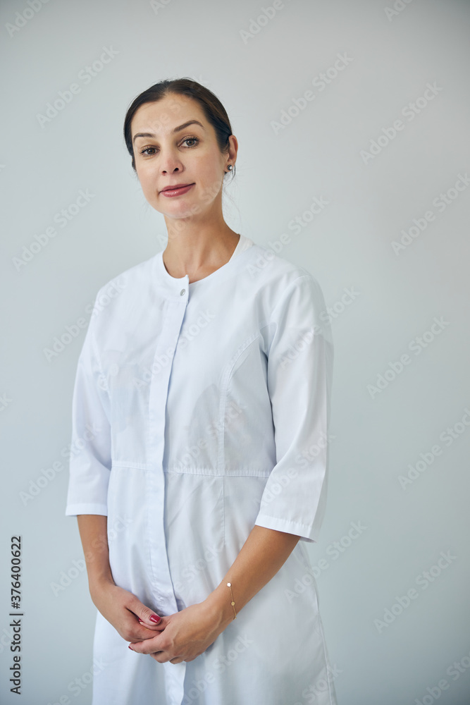 Professional dermatologist staring in front of her Professional dermatologist staring in front of her