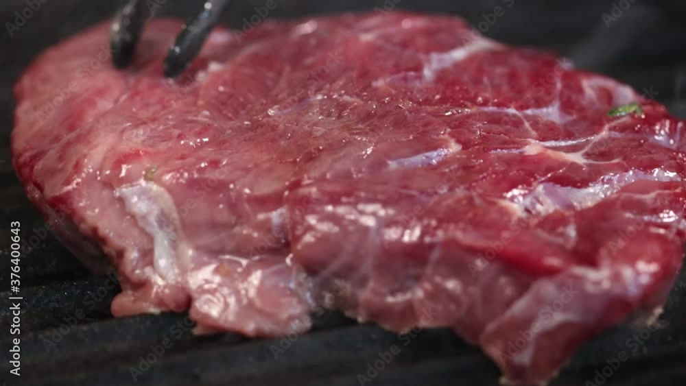 Piece of fresh raw beef meat steak prepared on a grill pan Piece of fresh raw beef meat steak prepared on a grill pan