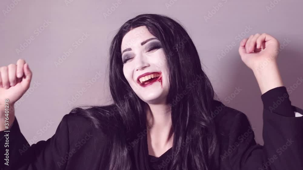 Young woman with halloween makeup dancing Young woman with halloween makeup dancing