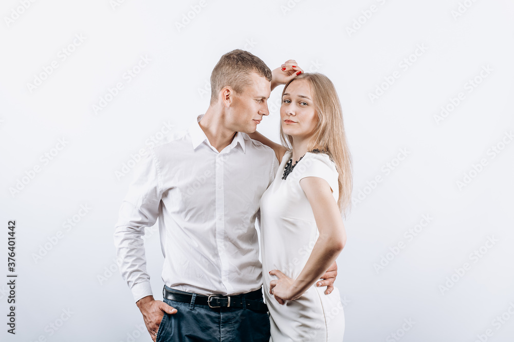Studio photo of passionate heterosexual couple posing over white background Studio photo of passionate heterosexual couple posing over white background