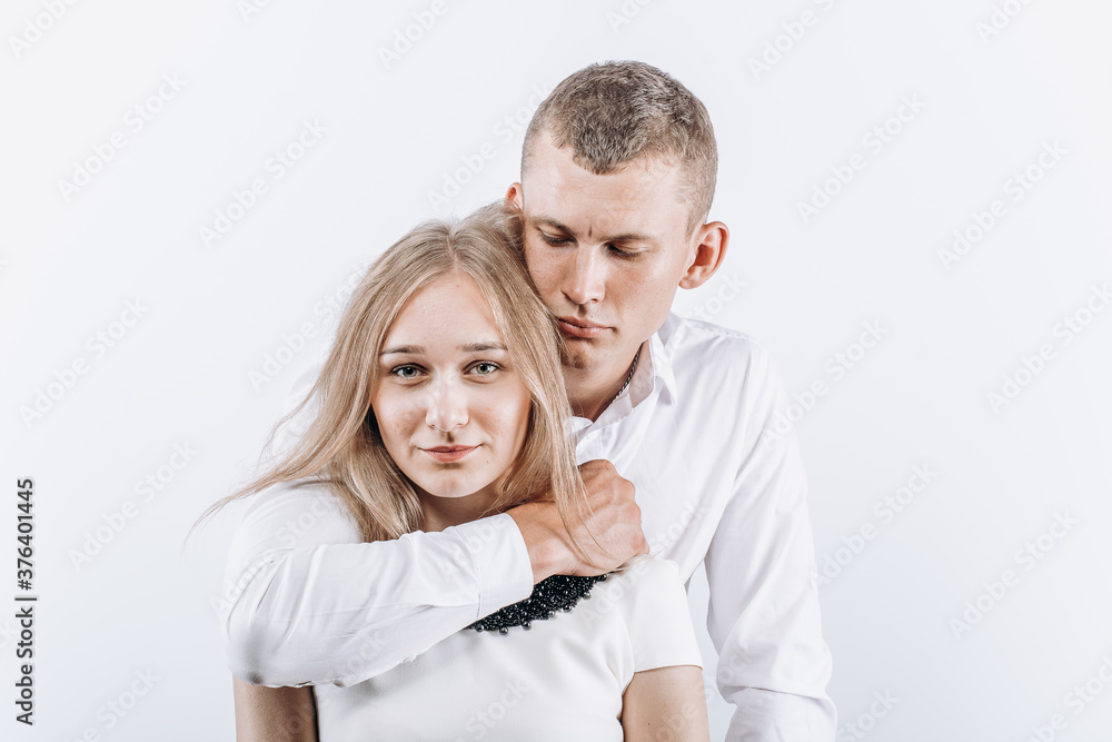 Fear abuse or domestic violence concept. The man hugs the woman menacingly Fear abuse or domestic violence concept. The man hugs the woman menacingly