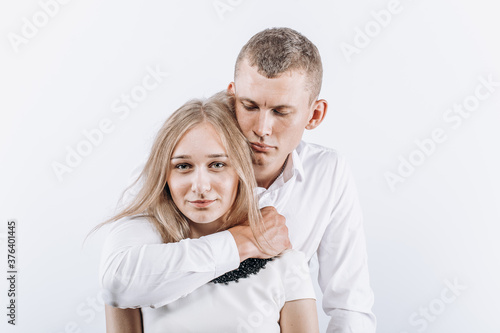 Fear abuse or domestic violence concept. The man hugs the woman menacingly