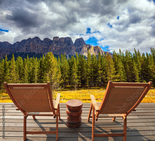 On platform there are two wicker deck chairs