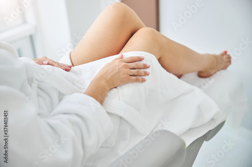 Barefoot female patient before a medical procedure
