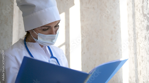 Female Doctor standing with folder photo