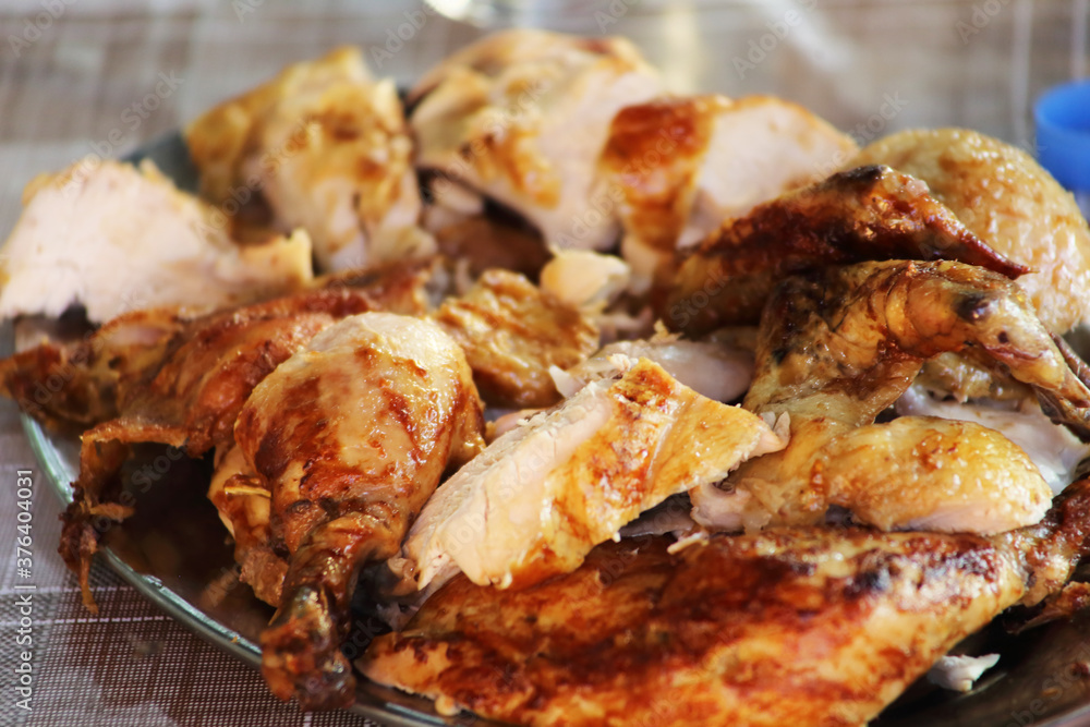 Rotisserie Chicken. Charcoal grilled chicken on the grill. Roast chicken on a divider. Served chicken. Rotisserie Chicken. Charcoal grilled chicken on the grill. Roast chicken on a divider. Served chicken.