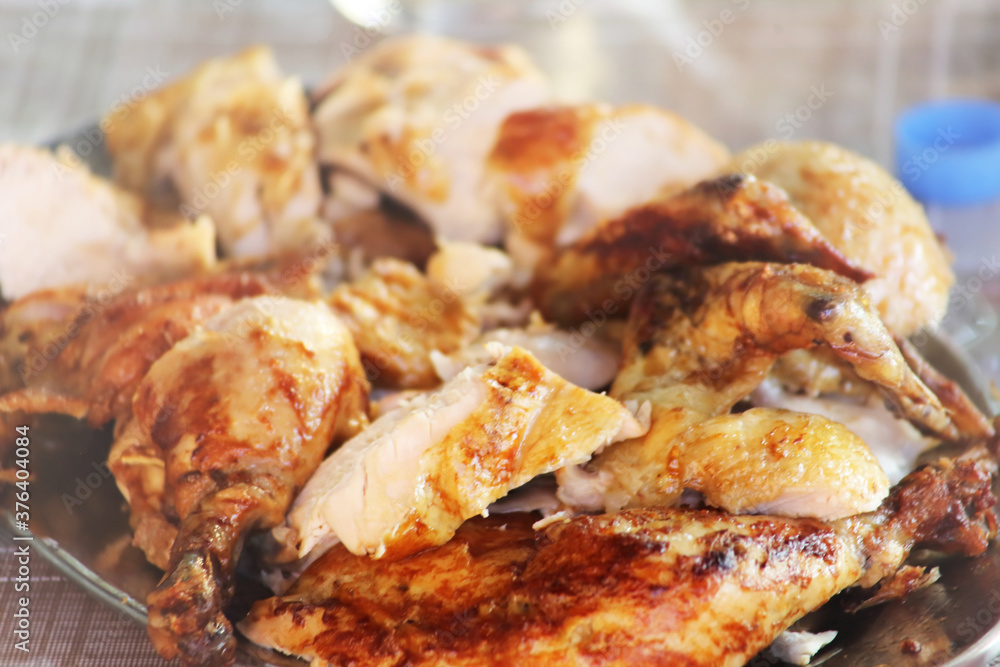Rotisserie Chicken. Charcoal grilled chicken on the grill. Roast chicken on a divider. Served chicken. Rotisserie Chicken. Charcoal grilled chicken on the grill. Roast chicken on a divider. Served chicken.