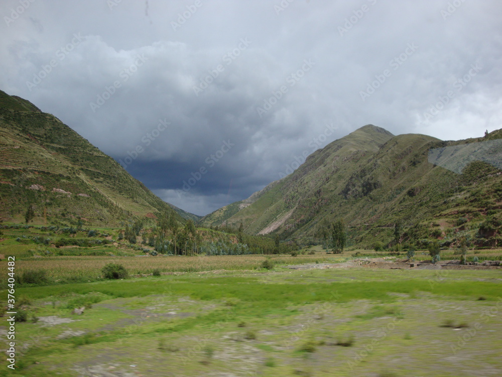 Villages and stonework near Cusco, Peru. sky green stone structures buildings fountains