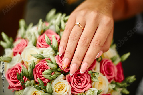 hands of the bride on bouqet