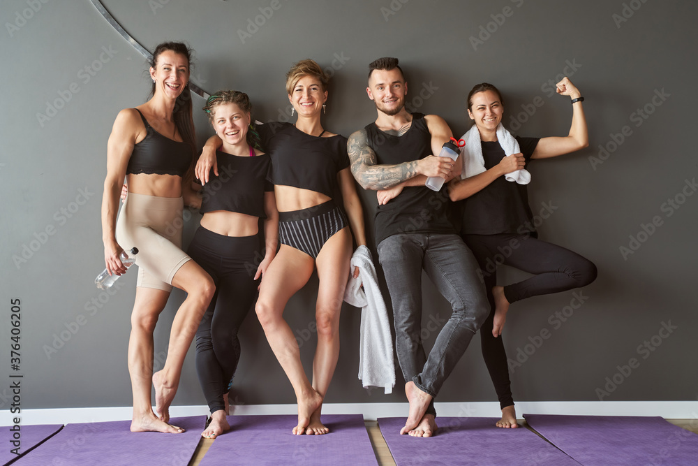 Fototapeta premium Yoga instructor talking to sport group while spending time in studio
