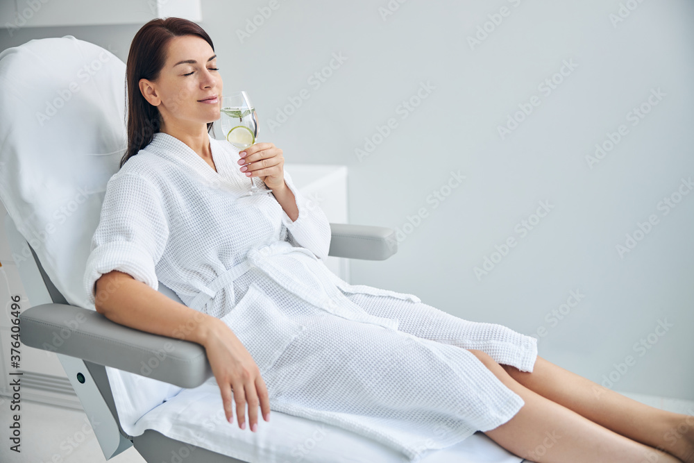 Serene woman relaxing before a beauty procedure Serene woman relaxing before a beauty procedure