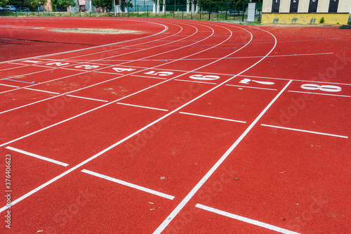 Treadmill with the numbers of the sports stadium. Track, running, red sports field In an open-air treadmill. Track number of the track at the stadium bend