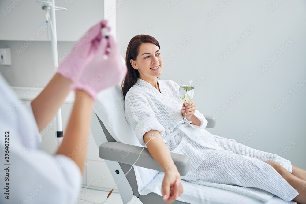 © Viacheslav Yakobchuk - Smiling woman with a catheter in her vein looking away © Viacheslav Yakobchuk - Smiling woman with a catheter in her vein looking away