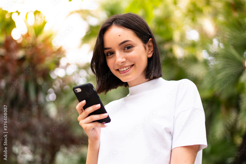 Young caucasian woman using a phone at outdoors Young caucasian woman using a phone at outdoors