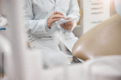 Healthcare worker typing on a tablet while at work