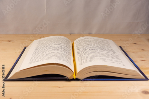 Open book on a natural wooden background