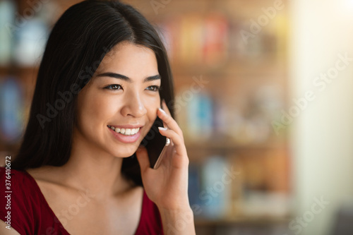 Phone Call. Closeup Portrait Of Beautiful Asian Girl Talking On Cellphone Indoors