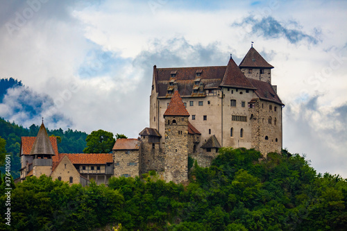 Scenic view of medieval Gutenberg Castle on hilltop between greenery on cloudy summer day, Balzers, Liechtenstein