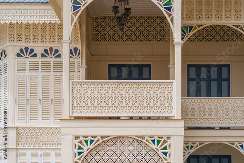 Wooden balcony woodcut trellis panel stencil lattice engraving decorative panel oriental geometric pattern exterior architecture traditional oriental Mosque historical building