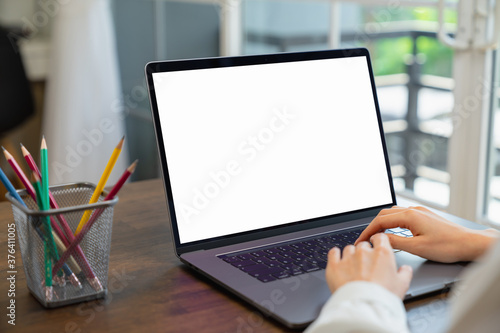Business women hand using laptop and type on the keyboard. Mockup screen of advertisement.