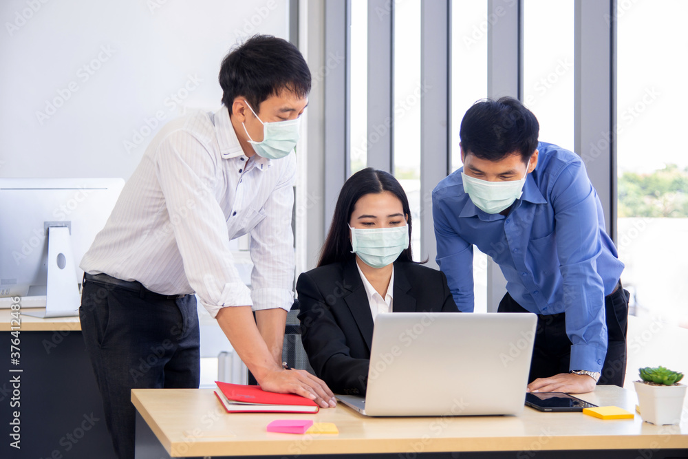 Office employee discuss their work with surgical mask for covid-19 outbreak prevention Office employee discuss their work with surgical mask for covid-19 outbreak prevention