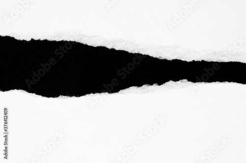 White ripped paper isolated on black background with copy space