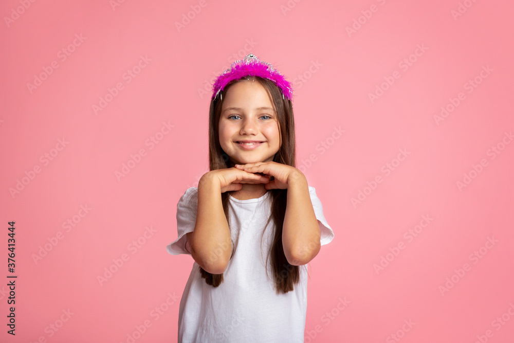 Childhood, beauty and fashion. Cheerful little girl with crown enjoys beauty Childhood, beauty and fashion. Cheerful little girl with crown enjoys beauty