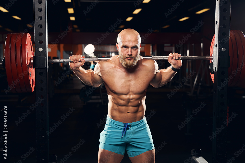 Male athlete working out with a barbell and weights Male athlete working out with a barbell and weights