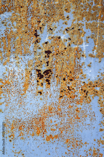 Corroded white metal background. Rusted white painted metal wall. Rusty metal background with streaks of rust. Rust stains. The metal surface rusted spots. Rysty corrosion.