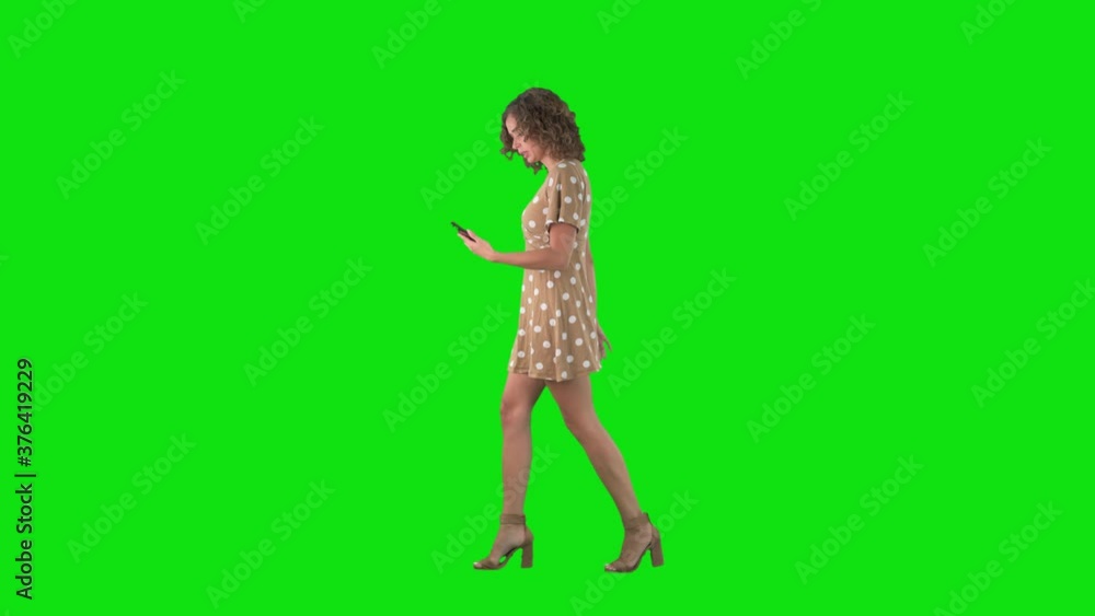 Side view of stressful young woman rushing in hurry for deadline checking time on phone on chroma key green screen. Side view of stressful young woman rushing in hurry for deadline checking time on phone on chroma key green screen.