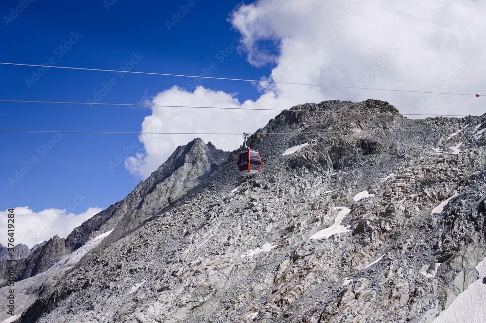 A cable car in the mountains on the italian Alps above clouds (Trentino, Italy, Europe)