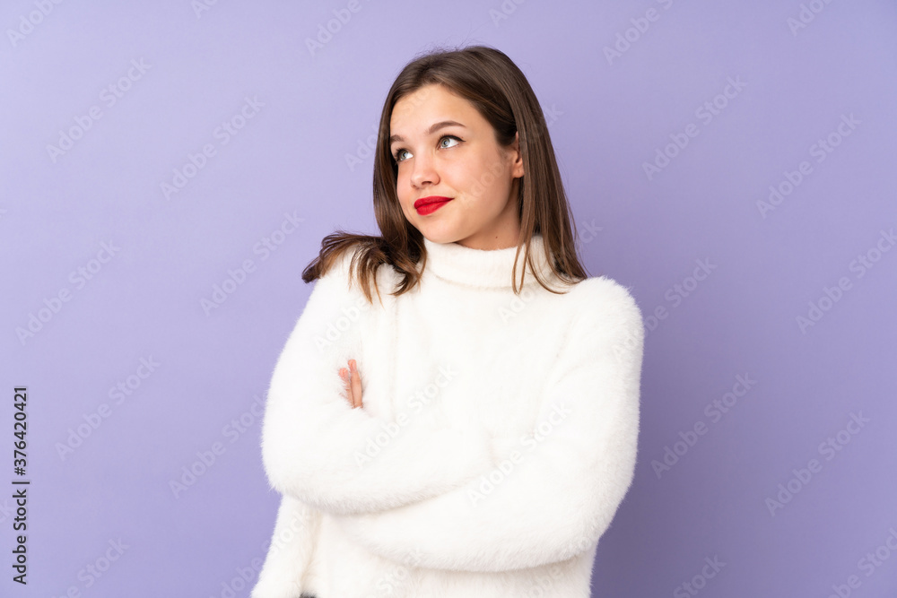 Teenager girl isolated on purple background making doubts gesture while lifting the shoulders