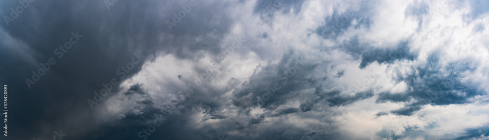 Moody panorama of dark dramatic stormy sky.