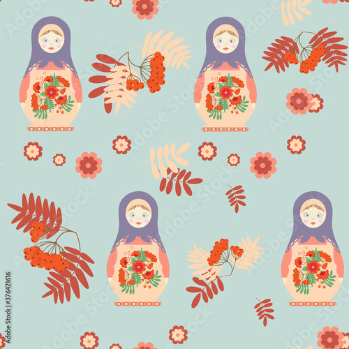 Seamless vector illustration with a Russian matreshka, with berries and a rowanberry leaves