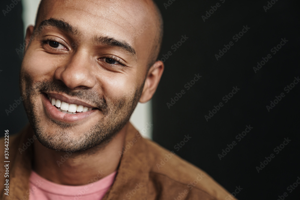 Image of smiling african american guy looking aside Image of smiling african american guy looking aside