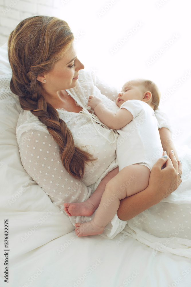 Small child with a woman. Baby with mom. High quality photo. Small child with a woman. Baby with mom. High quality photo.