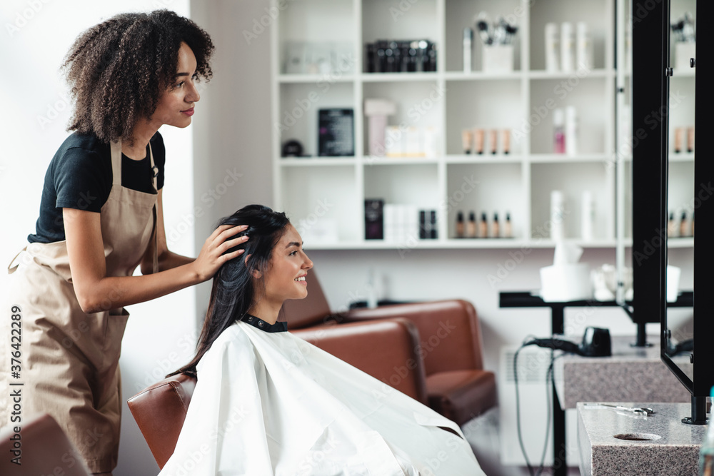 Young woman looking for changes, trying new hairstyle at beauty salon - obrazy, fototapety, plakaty 