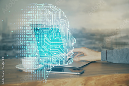 Businessman with computer background with brain theme hologram. Concept of brainstorm. Multi exposure.