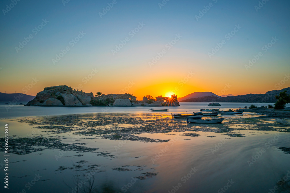 Amazing sunset view of Bafa lake is a peaceful place, ringed by traditional villages such as Kapıkırı full of fisherman boats and ruins of Herakleia