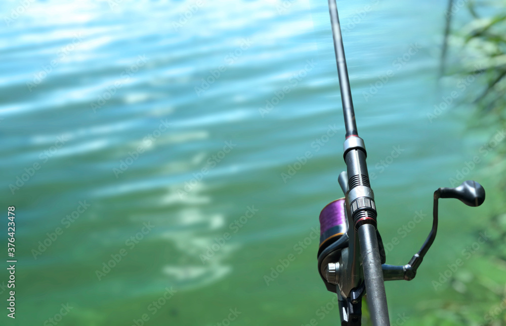 Fishing rod on a background of water. Fishing rod on a background of water.
