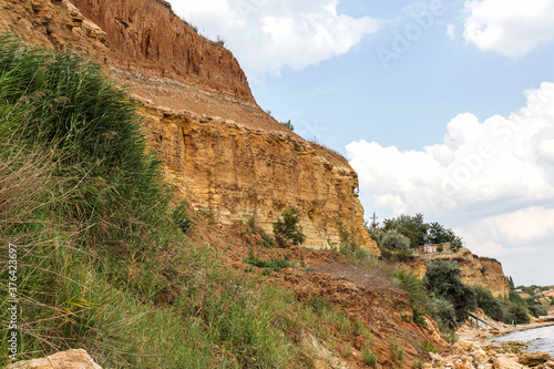 Landslide zone on Black Sea coast. Rock of sea rock shell. Zone of natural disasters during rainy season. Large masses of earth slip along slope of hill, destroy houses. Landslide - threat to life