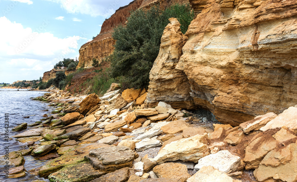 Landslide zone on Black Sea coast. Rock of sea rock shell. Zone of natural disasters during rainy season. Large masses of earth slip along slope of hill, destroy houses. Landslide - threat to life