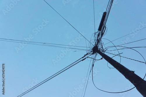 Silhouette of electricity pole from below taken from several angle.