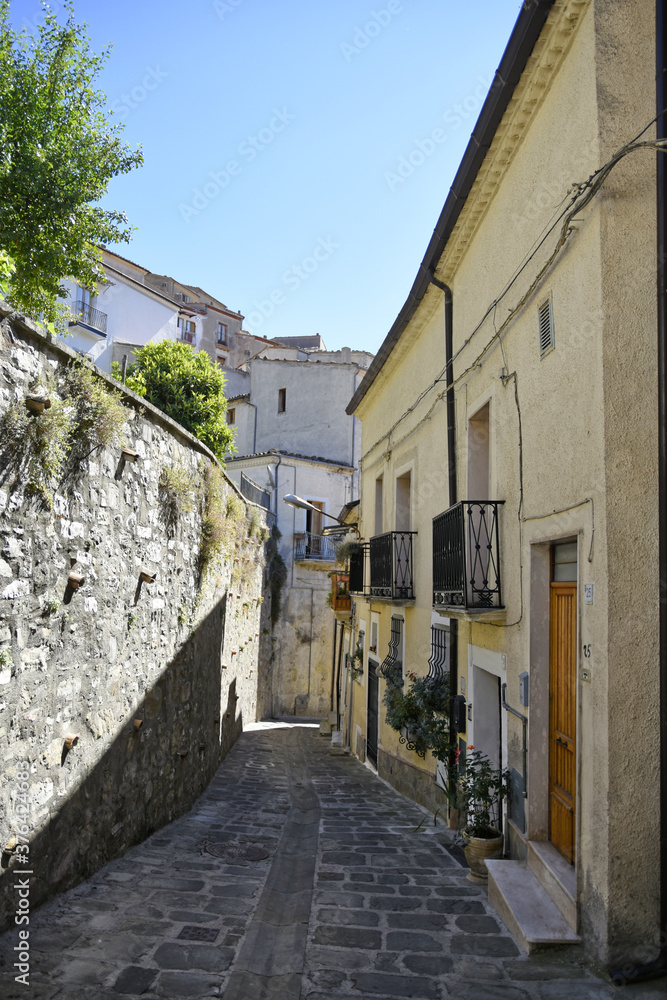 Fototapeta premium A small road crosses the old buildings of Calvello, a old Town in the Basilicata region, Italy.