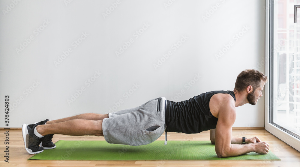 Obraz premium Handsome man working out at home