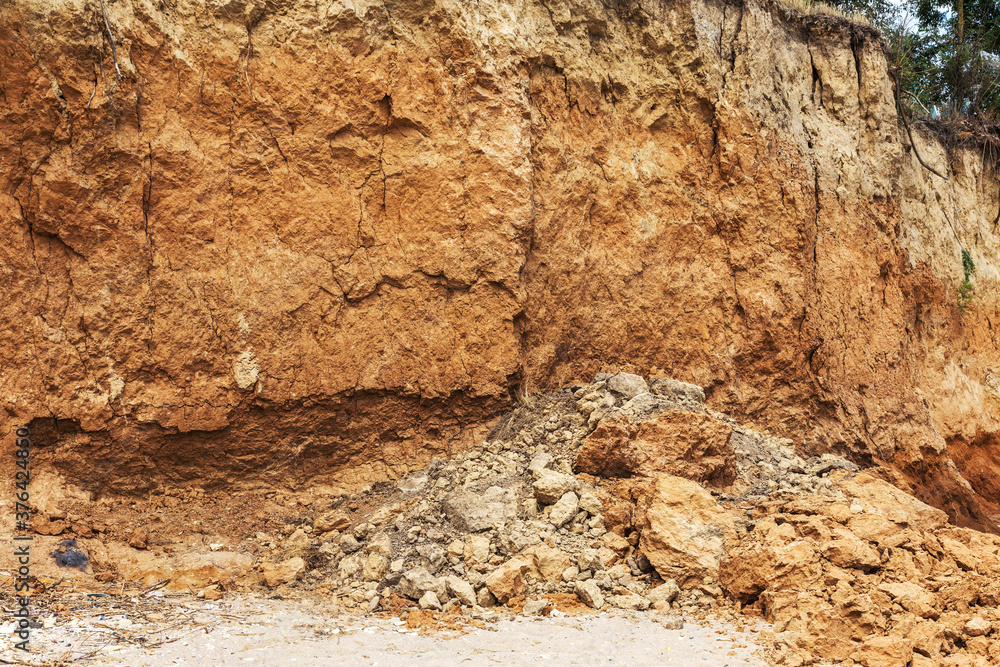 Landslide zone on Black Sea coast. Rock of sea rock shell. Zone of natural disasters during rainy season. Large masses of earth slip along slope of hill, destroy houses. Landslide - threat to life