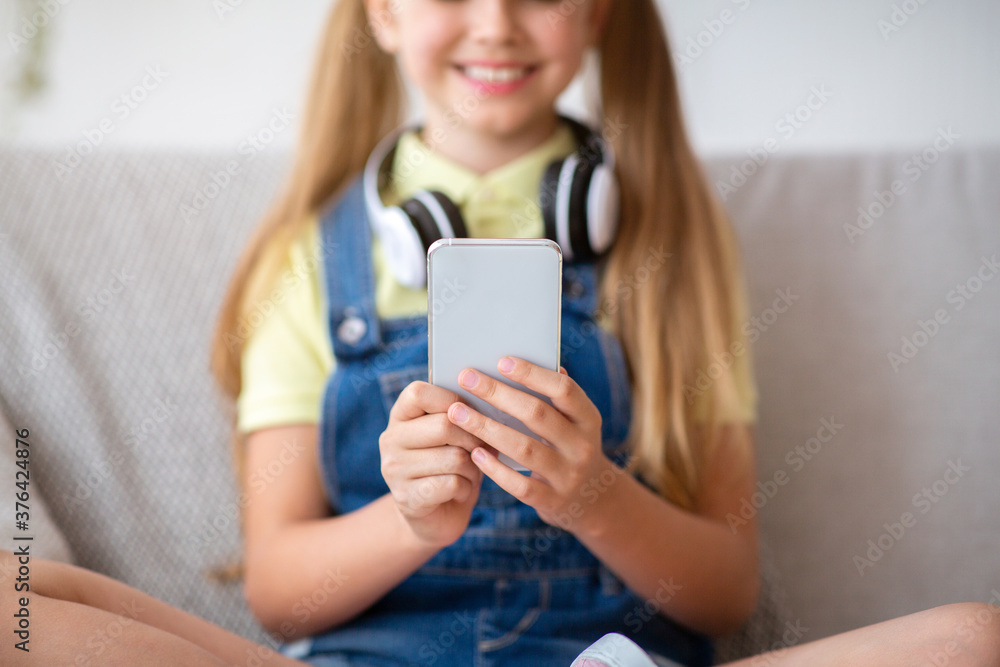 Girl wearing headset enjoying music with phone Girl wearing headset enjoying music with phone